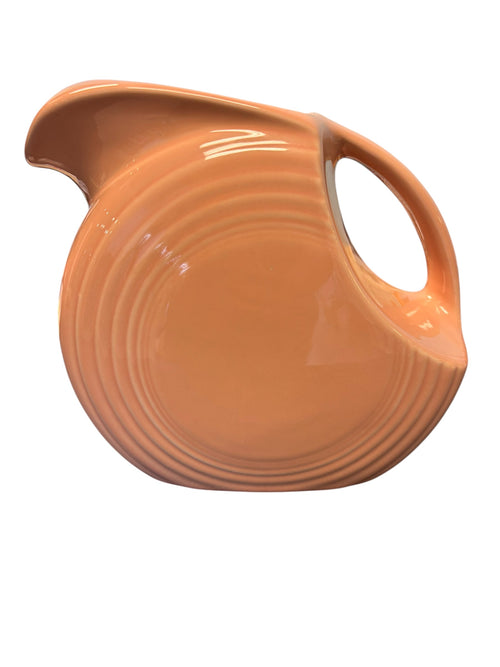 This is a Fiesta Fiestaware Large Disc Water Pitcher in Apricot. lead-free, Post 1986, Retired Color Retired Shape 67 ounce capacity