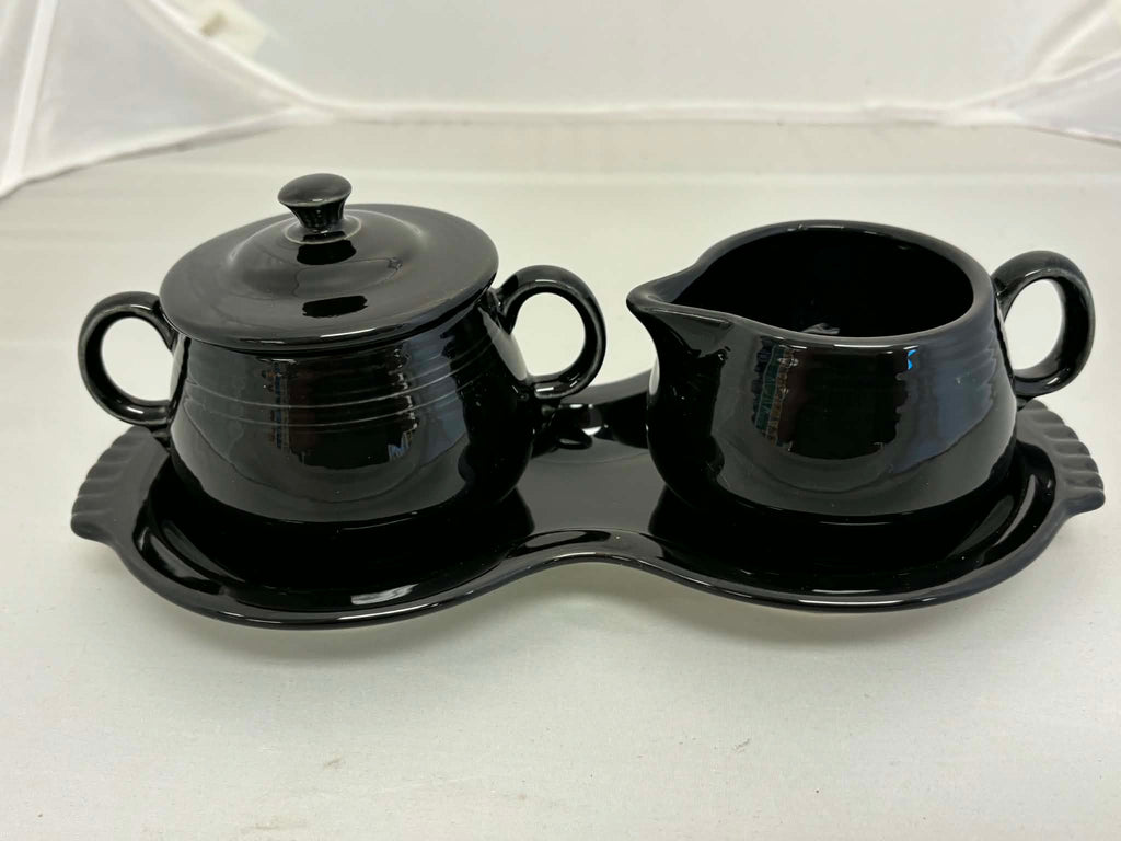 This is a Fiesta Fiestaware Creamer Pitcher Sugar Bowl with Lid on Figure Eight 8 Tray Set in black. lead-free, Post 1986, Retired Color Retired Shape

