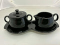 This is a Fiesta Fiestaware Creamer Pitcher Sugar Bowl with Lid on Figure Eight 8 Tray Set in black. lead-free, Post 1986, Retired Color Retired Shape
