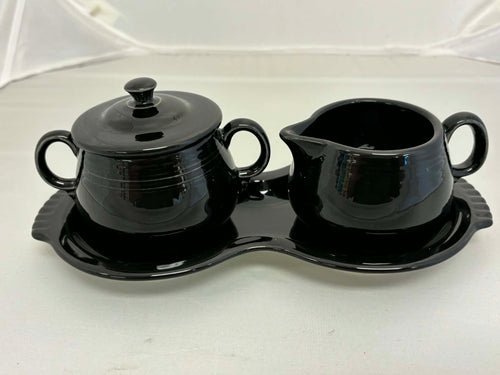 This is a Fiesta Fiestaware Creamer Pitcher Sugar Bowl with Lid on Figure Eight 8 Tray Set in black. lead-free, Post 1986, Retired Color Retired Shape
