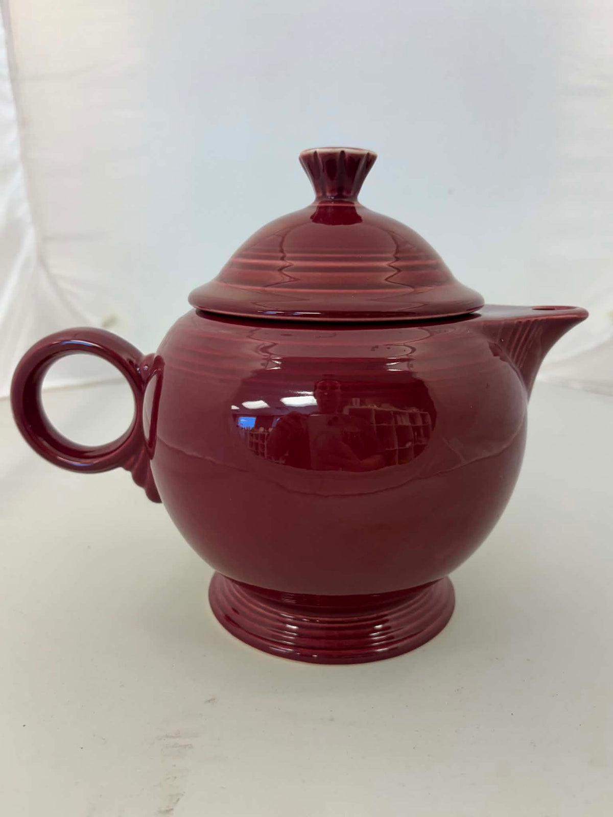 This is a Fiesta Fiestaware Five-cup 5-cup Ring Handled Tea Pot with Lid in Cinnabar. lead-free, Post 1986, Retired Color Retired Shape
