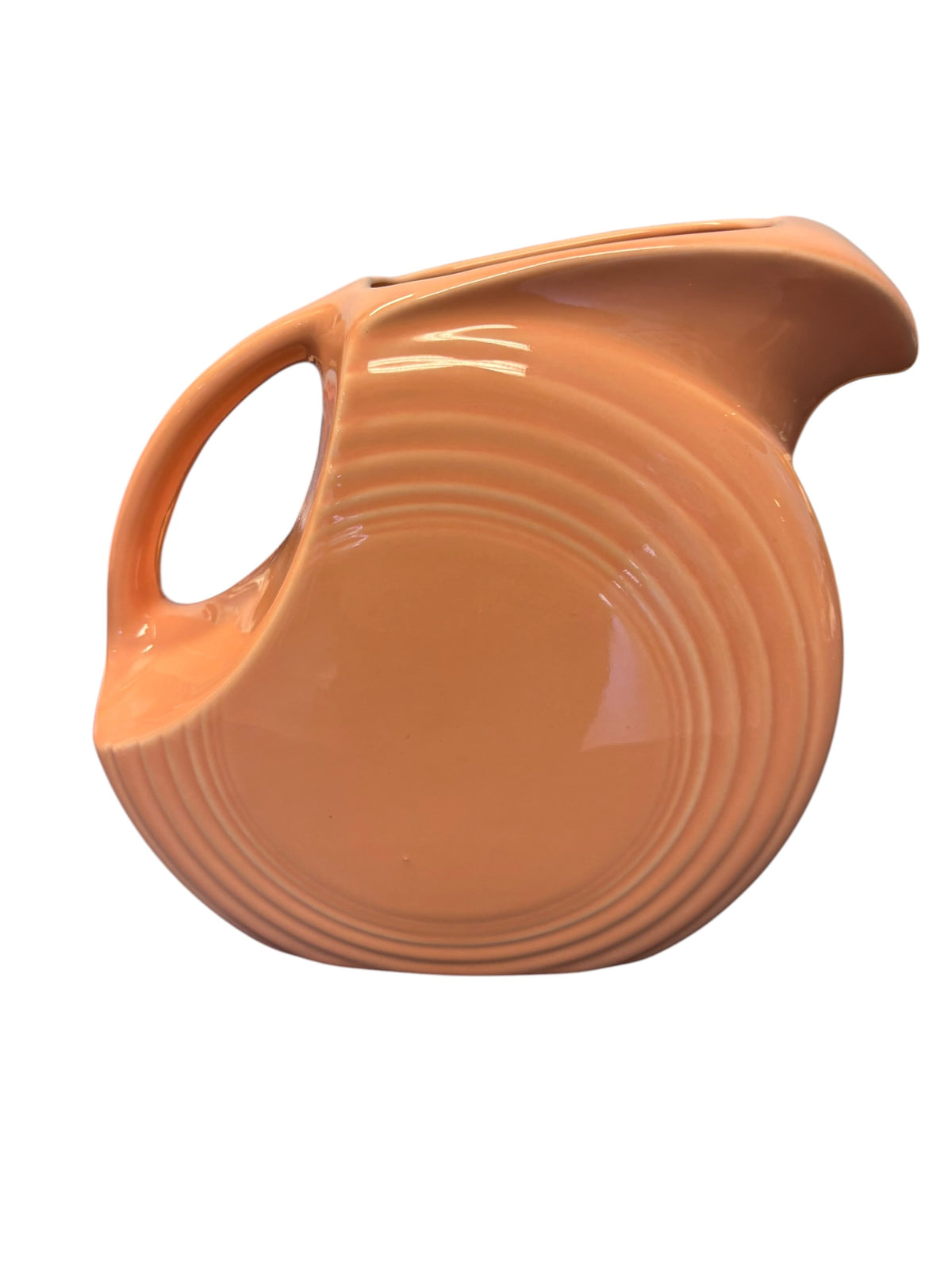 This is a Fiesta Fiestaware Large Disc Water Pitcher in Apricot. lead-free, Post 1986, Retired Color Retired Shape 67 ounce capacity
