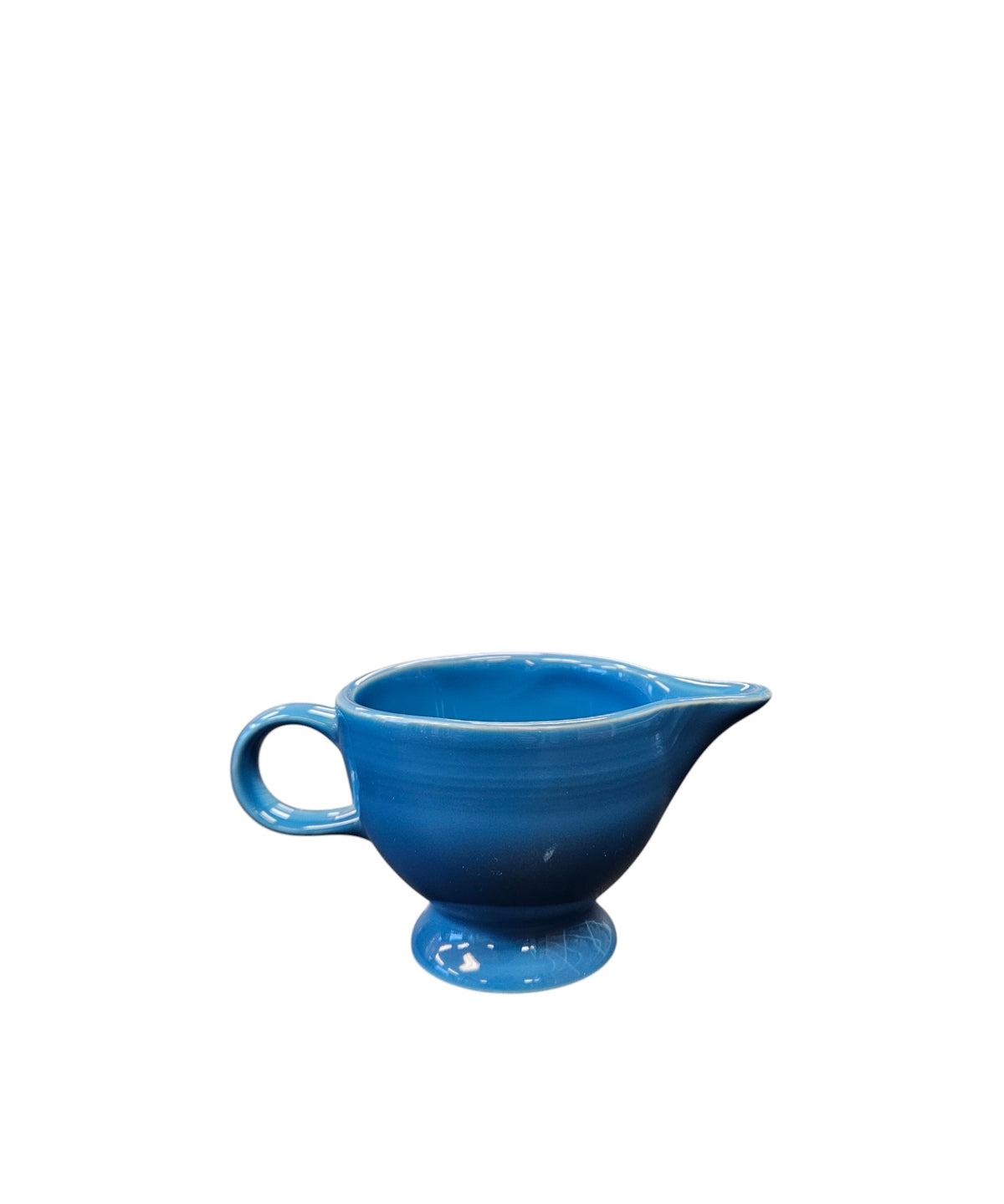 This is a Fiesta Fiestaware individual cream pitcher creamer in Peacock. lead-free, Post 1986, Retired Color Retired Shape

