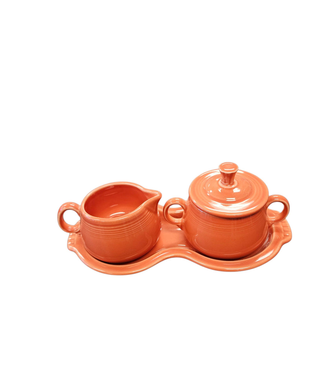 This is a Fiesta Fiestaware Creamer Pitcher Sugar Bowl with Lid on Figure Eight 8 Tray Set in persimmon lead-free, Post 1986, Retired Color Retired Shape
