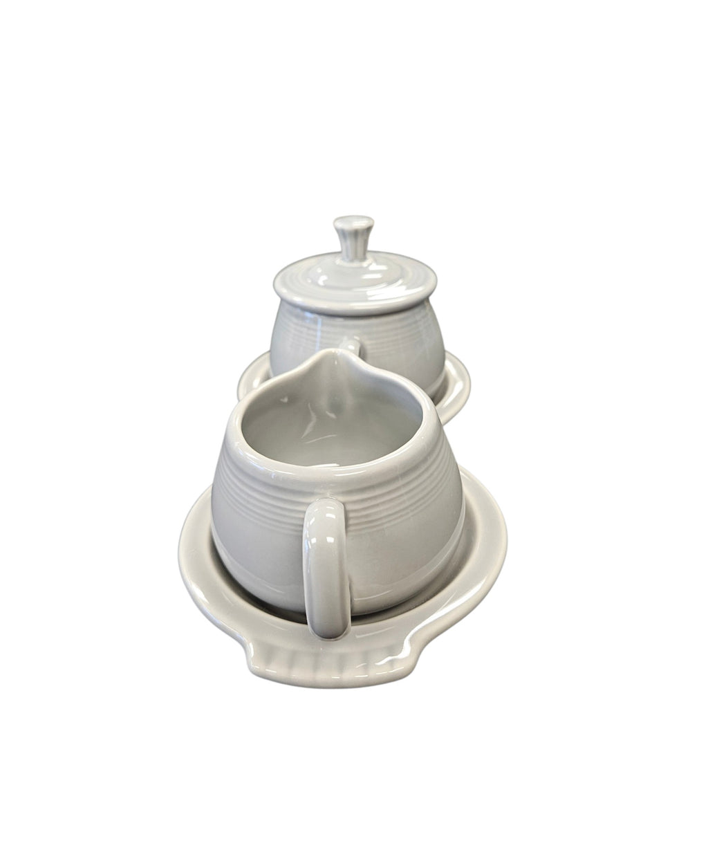 This is a Fiesta Fiestaware Creamer Pitcher Sugar Bowl with Lid on Figure Eight 8 Tray Set in pearl gray lead-free, Post 1986, Retired Color Retired Shape
