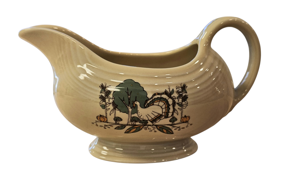 This is a Fiesta fiestaware Sauce Gravy Boat featuring Everything Kitchen's Fall Forest decal on Ivory. Lead free, Post 1986 Retired Decal, Retired Color, limited quantities available via EK, Fall, Greenery, Cabin, Bird, Turkey, Tree, Thanksgiving
