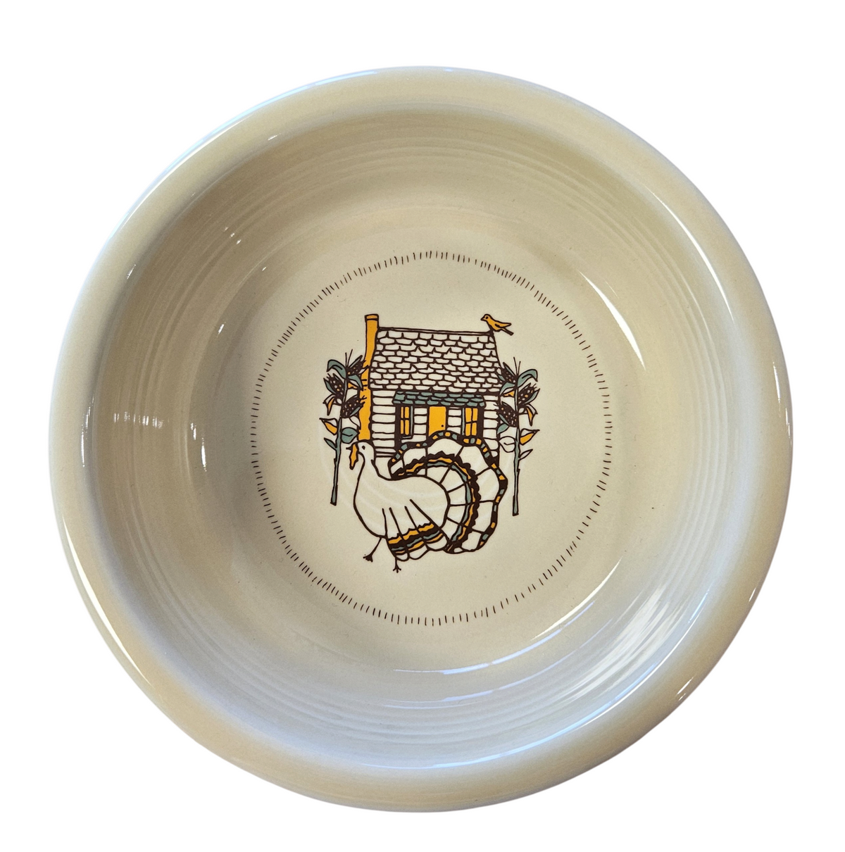 This is a Fiesta fiestaware Classic Rim Cereal Bowl featuring Everything Kitchen's Fall Forest decal on Ivory. Lead free, Post 1986 Retired Decal, Retired Color, limited quantities available via EK, Fall, Greenery, Cabin, Bird, Turkey, Tree, Thanksgiving
