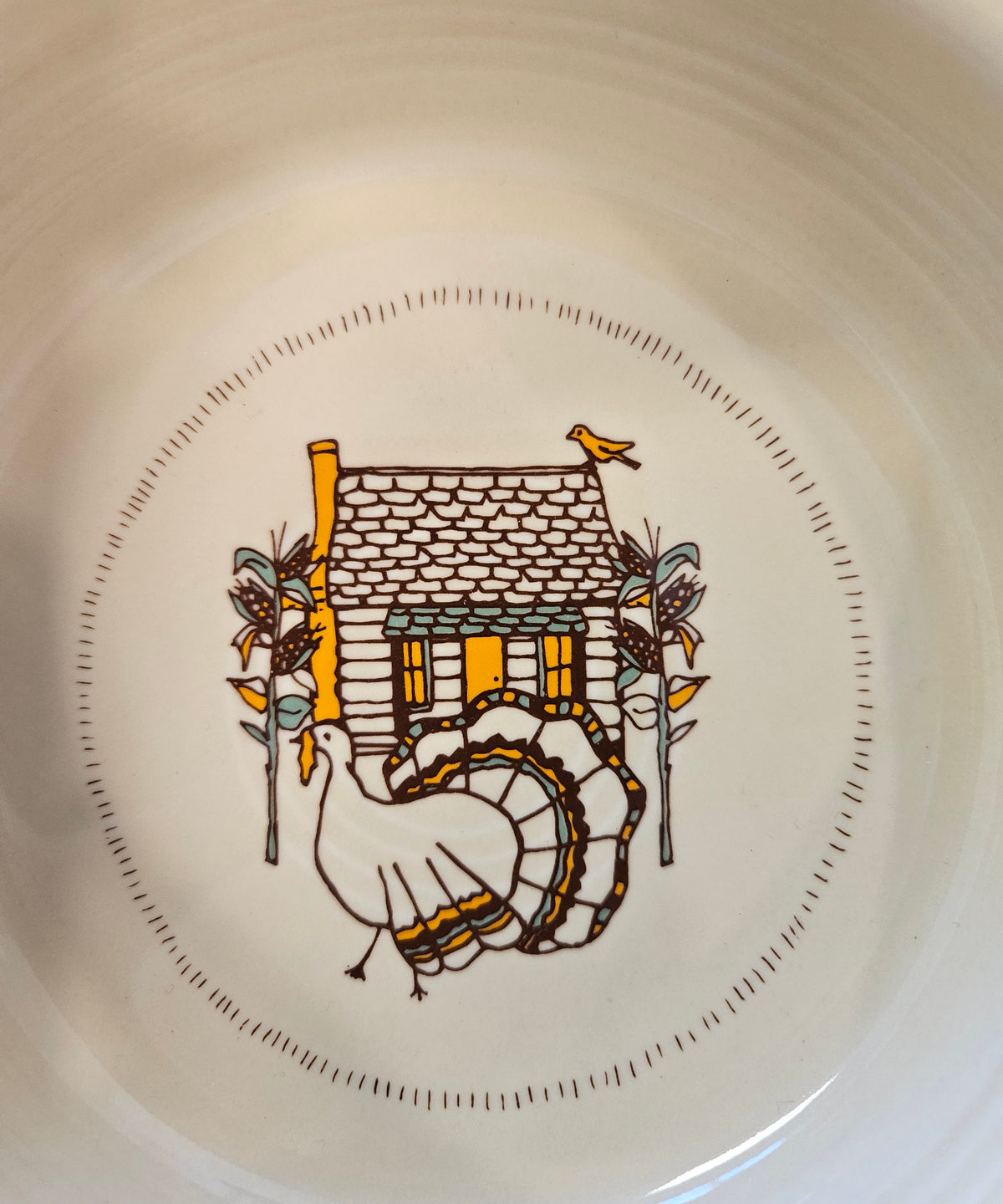 This is a Fiesta fiestaware Classic Rim Cereal Bowl featuring Everything Kitchen's Fall Forest decal on Ivory. Lead free, Post 1986 Retired Decal, Retired Color, limited quantities available via EK, Fall, Greenery, Cabin, Bird, Turkey, Tree, Thanksgiving
