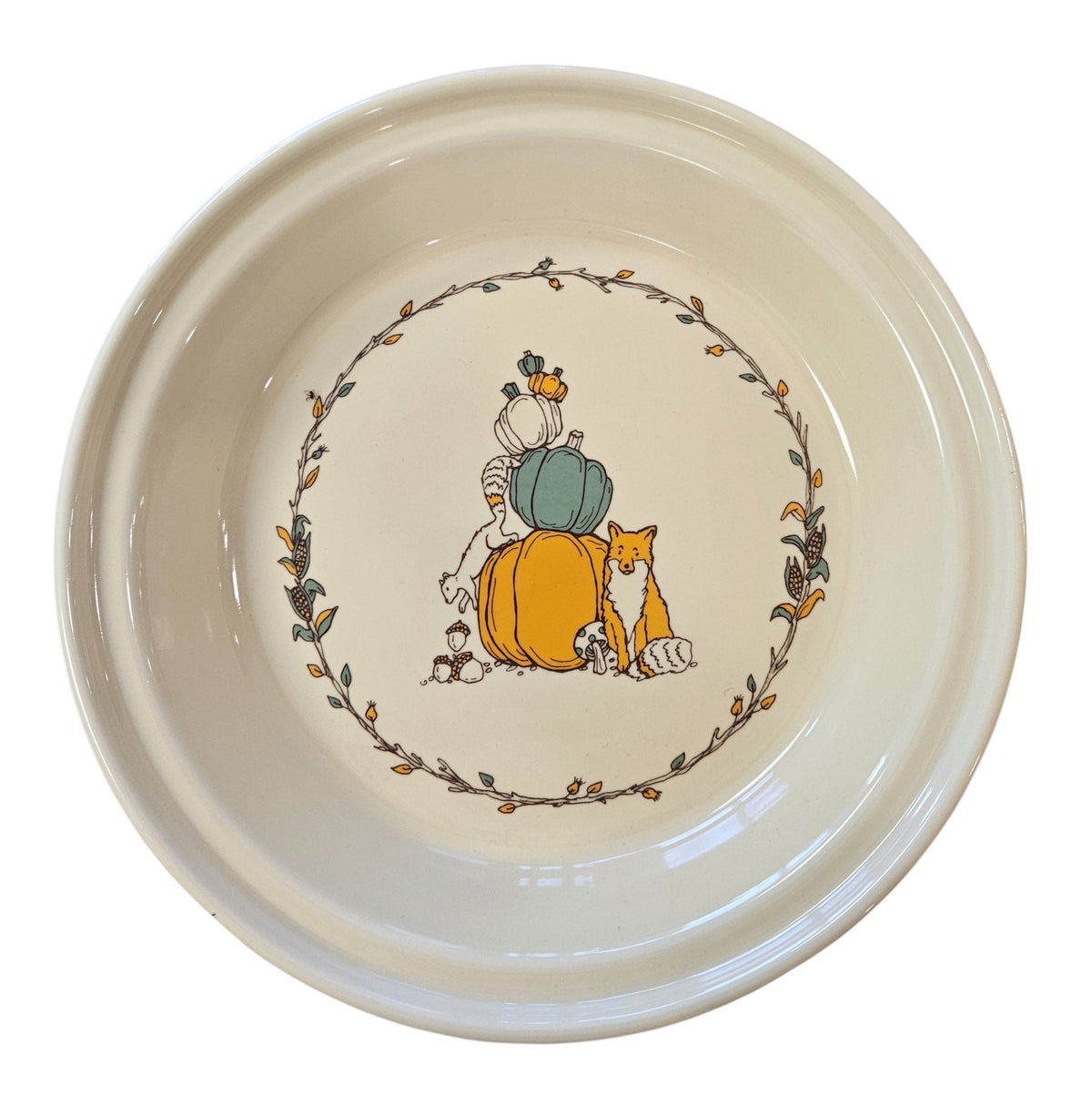 This is a Fiesta fiestaware Large Pie Baker featuring Everything Kitchen's Fall Forest decal on Ivory. Lead free, Post 1986 Retired Decal, Retired Color, limited quantities available via EK, Fall, Greenery, Cabin, Bird, Turkey, Tree, Thanksgiving
