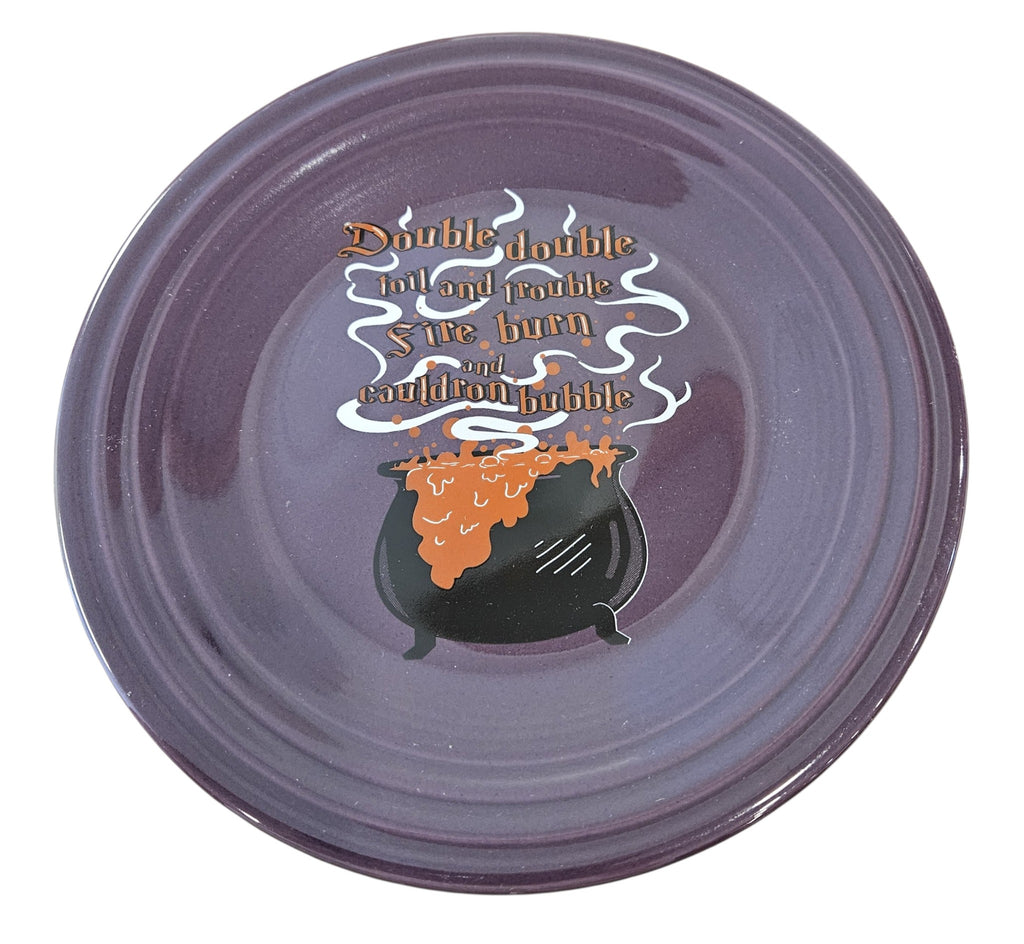 This is a Fiesta fiestaware Classic Luncheon Plate featuring the Halloween Cauldron decal on mulberry. The decal reads :Double double toil and trouble fire burn and cauldron bubble". Lead free, Post 1986 retired decal, retired color, Halloween
