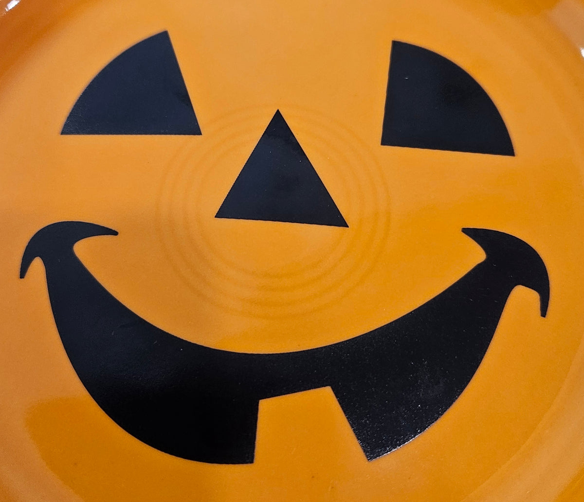 This is a Fiesta fiestaware Bistro Appetizer Plate featuring the Happy Pumpkin decal on tangerine. Lead free, Post 1986, Retired Production Decal, Retired Color, Fall, Thanksgiving, Halloween
