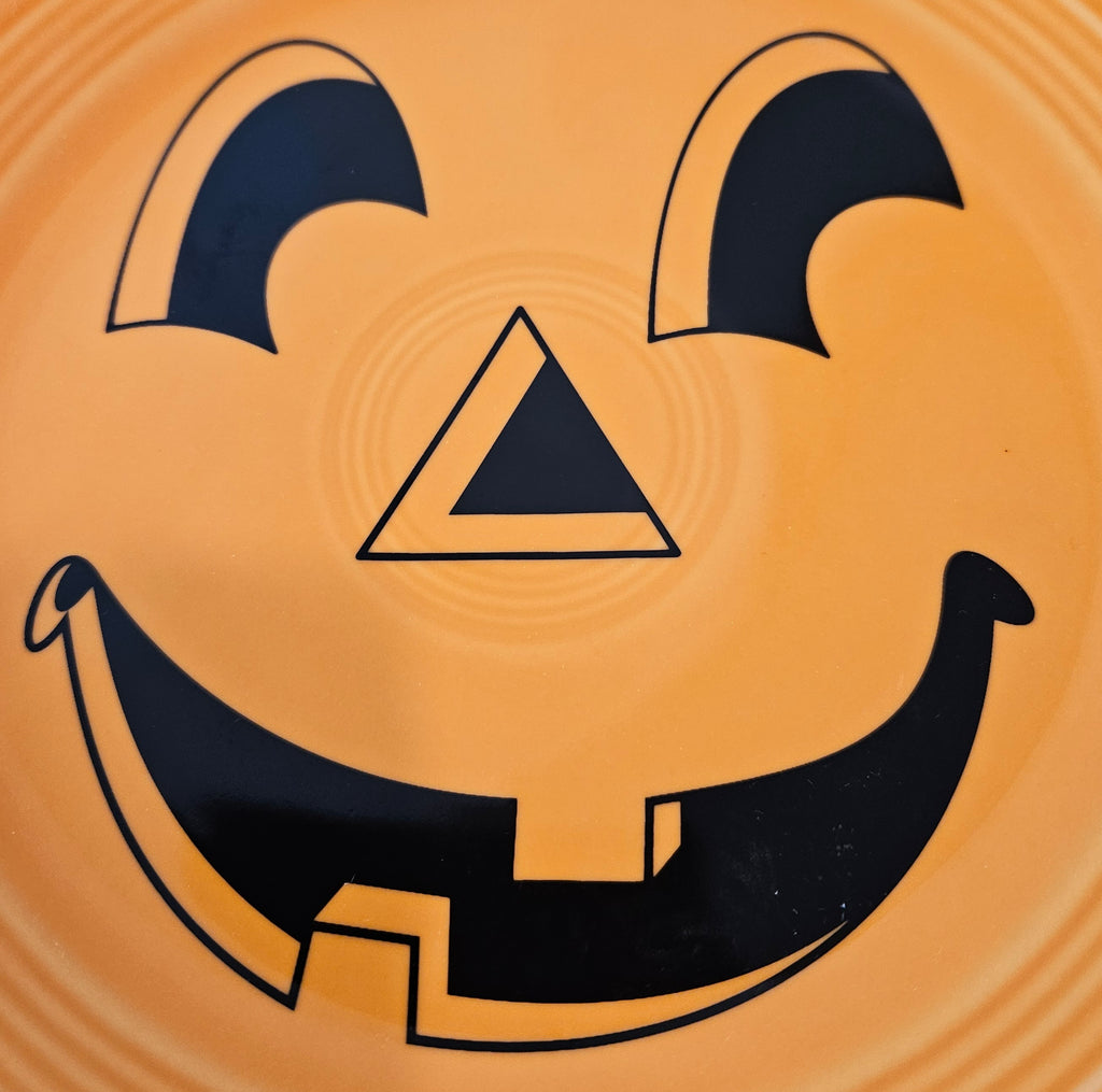 This is a Fiesta fiestaware Classic Luncheon Plate featuring the Carson's Exclusive Pumpkin decal on tangerine. Lead free, Post 1986 retired decal, retired color, Halloween
