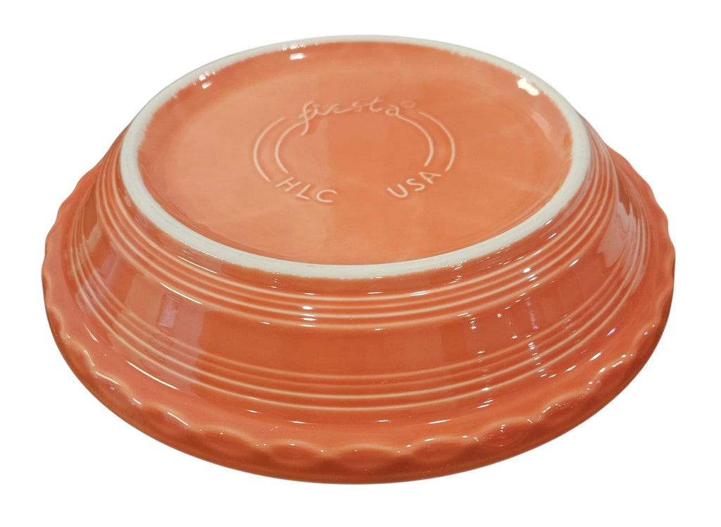 This is a Fiesta fiestaware Large Pie Baker featuring the Happy Pumpkin decal on persimmon. Lead free, Post 1986, Retired Production Decal, Retired Color, Fall, Thanksgiving, Halloween
