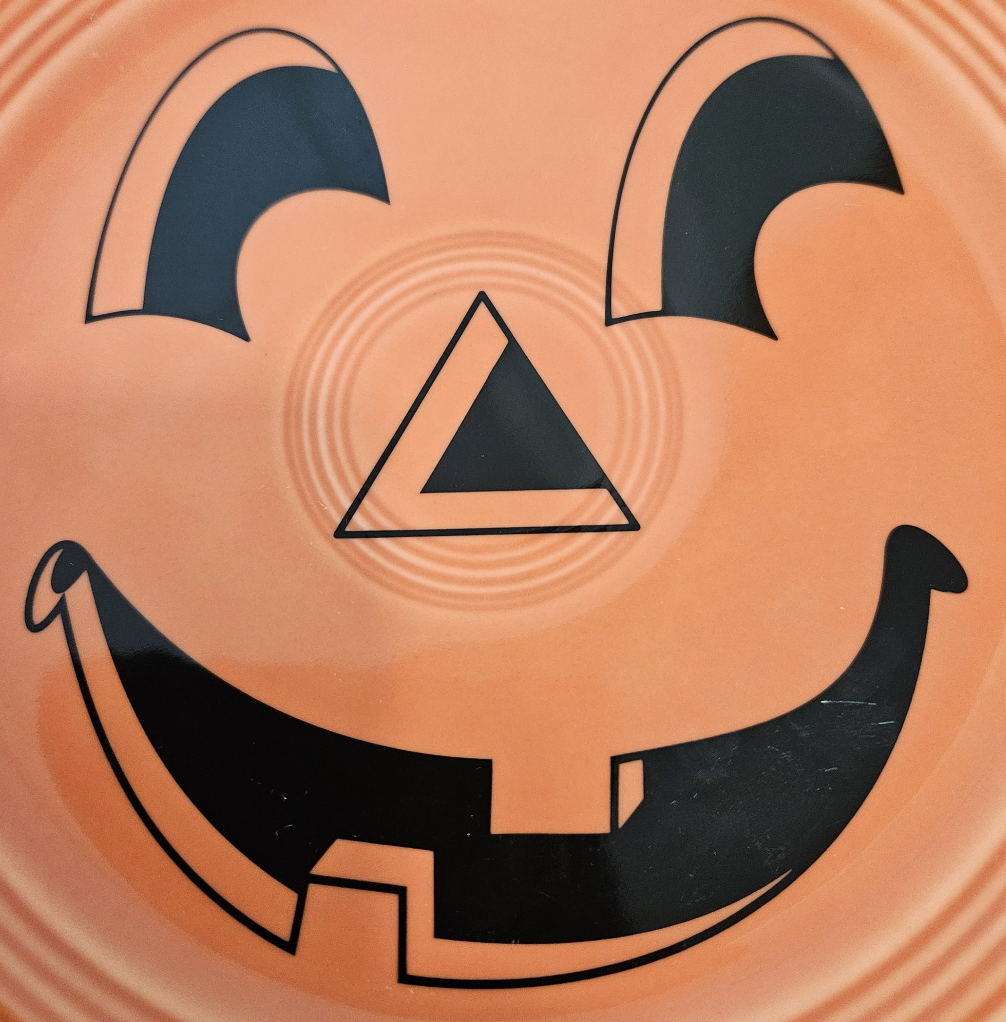 This is a Fiesta fiestaware Classic Luncheon Plate featuring the Carson's Exclusive Pumpkin decal on persimmon. Lead free, Post 1986 retired decal, retired color, Halloween
