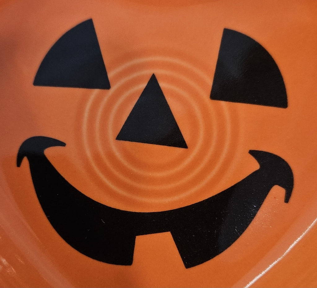 This is a Fiesta fiestaware Small Heart Bowl featuring the FTCCO 2024 exclusive Happy Pumpkin decal on poppy. Lead free, Post 1986, Fall, Thanksgiving, Halloween
