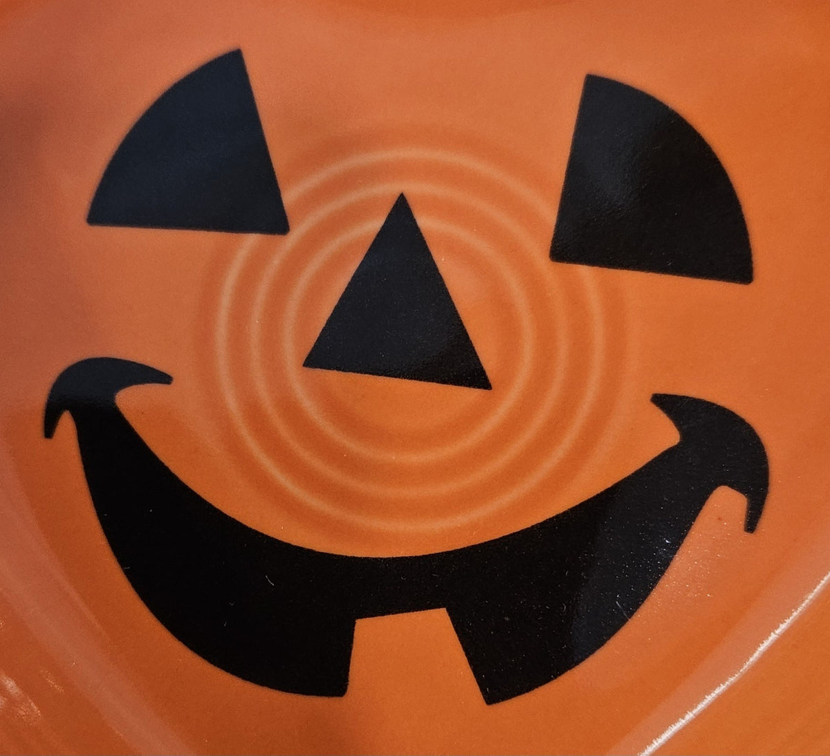 This is a Fiesta fiestaware Small Heart Bowl featuring the FTCCO 2024 exclusive Happy Pumpkin decal on poppy. Lead free, Post 1986, Fall, Thanksgiving, Halloween

