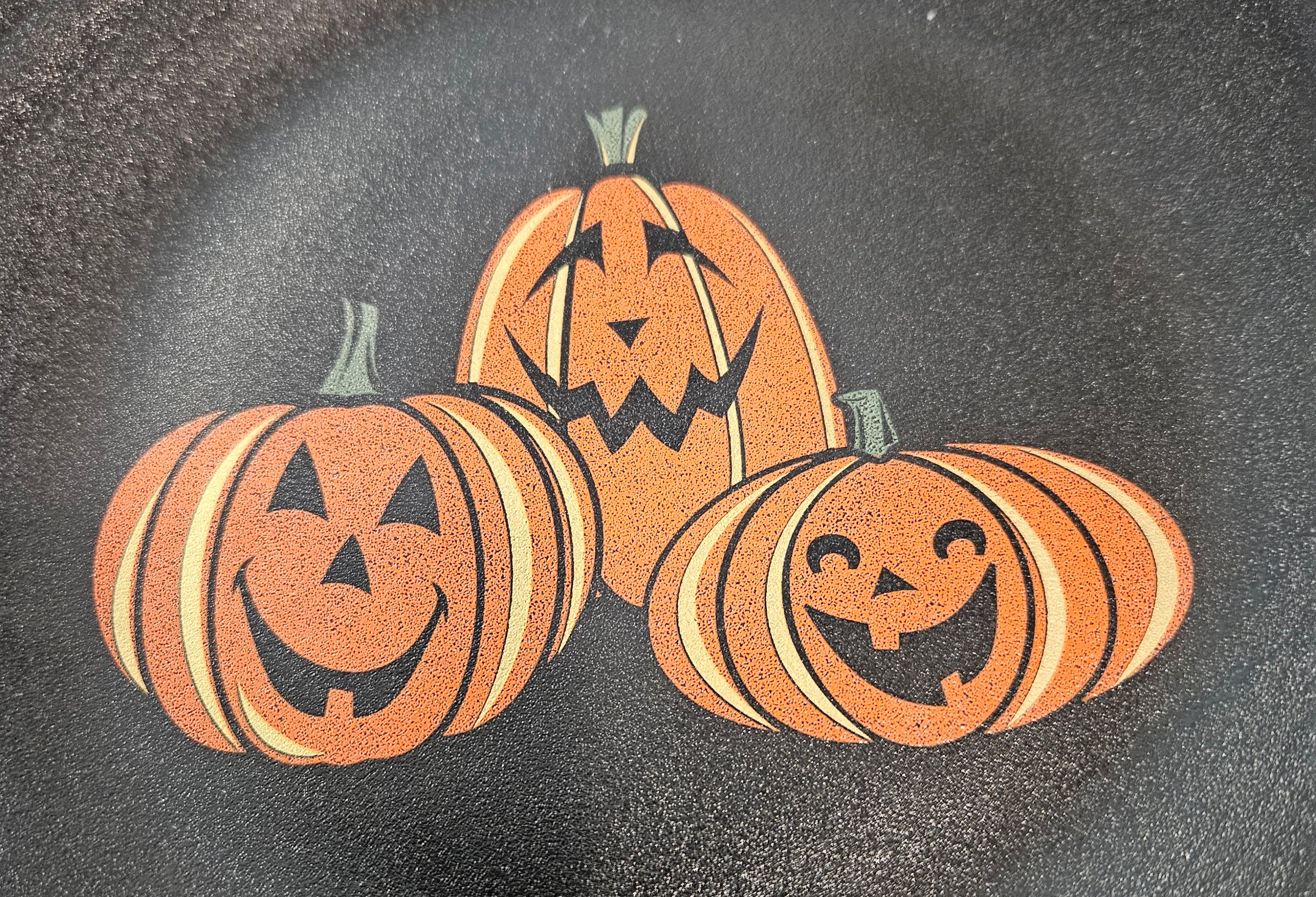 This is Fiesta fiestware Classic Luncheon Plate featuring the Trio of Happy Pumpkins decal on black/foundry. Lead free, post 1986, retired decal, limited production color, Halloween
