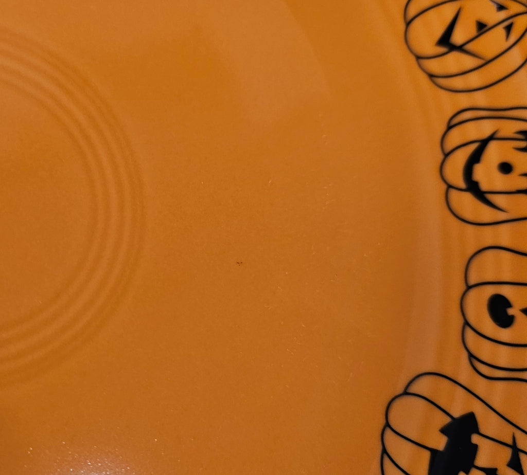 This is a Fiesta fiestaware Classic Luncheon Plate featuring the Carson's Exclusive Jack O' Lanterns decal on tangerine. Lead free, Post 1986 retired decal, retired color, Halloween

