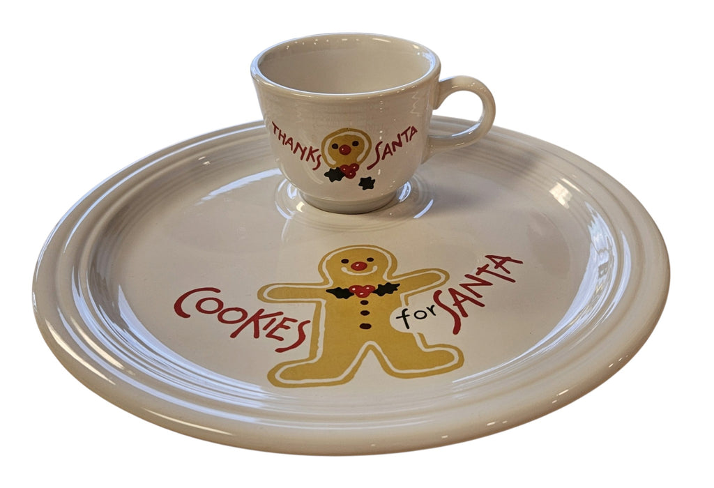 This is a Fiesta Fiestaware Welled Snack Plate and Cup featuring Betty Crocker's original Cookies for Santa Gingerbread decal on White. Post 1986, Lead-free, Decorated, Retired Decal, Christmas. The set went under General Release after Betty Crocker shut down their catalog. The set comes with the original box and packaging.
