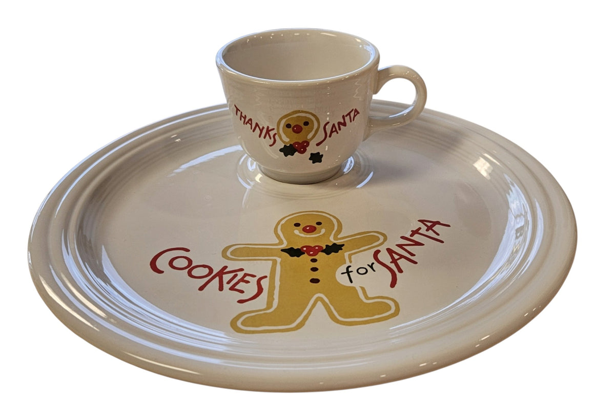 This is a Fiesta Fiestaware Welled Snack Plate and Cup featuring Betty Crocker's original Cookies for Santa Gingerbread decal on White. Post 1986, Lead-free, Decorated, Retired Decal, Christmas. The set went under General Release after Betty Crocker shut down their catalog. The set comes with the original box and packaging.
