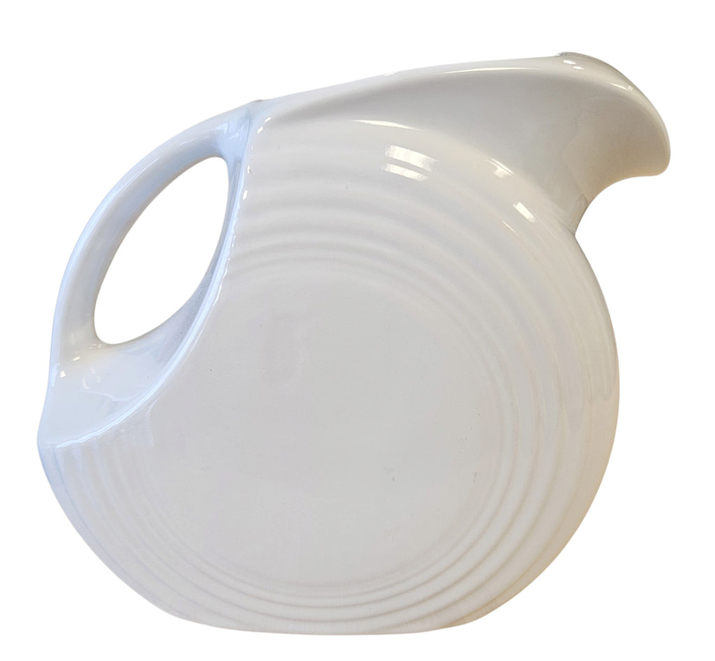 This is a Fiesta Fiestaware Large Disk Pitcher featuring hand-painted artwork by Patricia Degraw on white. The artwork is reflective of Christmas and the Holidays with reds and greens paint hues, holly and berries and a partial mandala pattern. Decorated, Post-1986, Lead-Free
