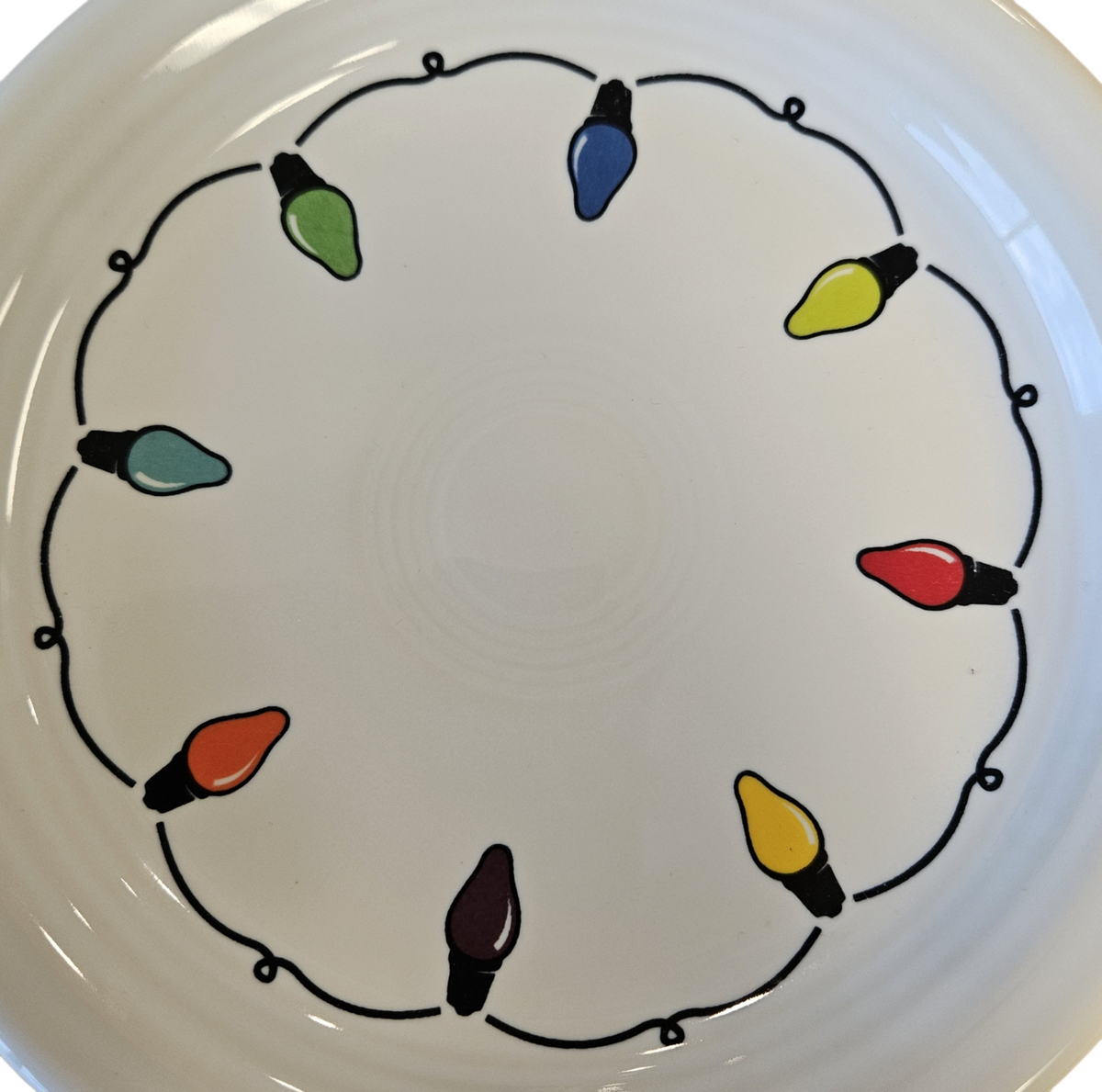 This is a Fiesta Fiestaware Bistro Appetizer Plate featuring the decal sometimes called Bon-Ton's Christmas Lights, String of Lights, or Holiday Lights on White. Post 1986, Lead-free, Christmas, Tree, Decorated, Retired Decal
