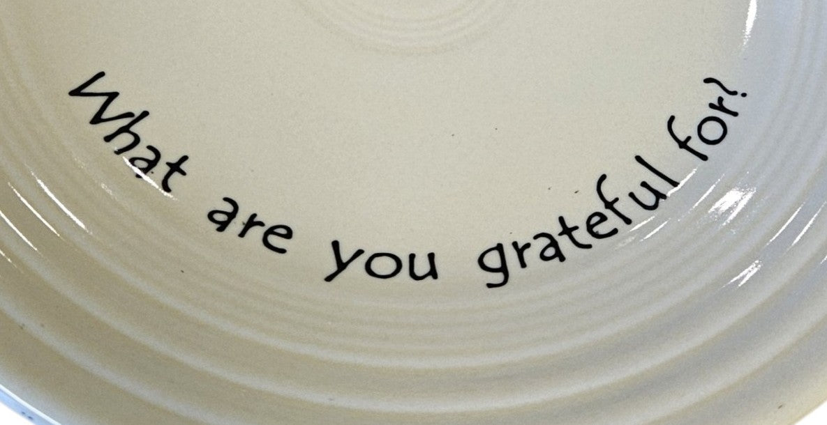 This is a Fiesta Fiestaware Classic Luncheon Plate featuring Fiesta's exclusive Café Gratitude "What are you Gratefuk For?" decal  on Ivory. The decal was created as a conversation or "pass along" piece to encourage reflection and gratitude during meals. Post 1986, Lead-free, Thanksgiving, Fall, Christmas, Decorated, Retired Decal
