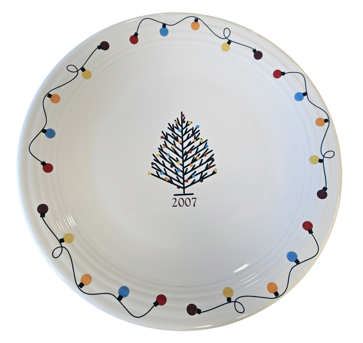 This is a Fiesta Fiestaware Chop Plate featuring JC Penney's exclusive 2007 String of Lights, AKA Light Motif on White. Post 1986, Lead-free, Christmas, Tree, Decorated, Decal
