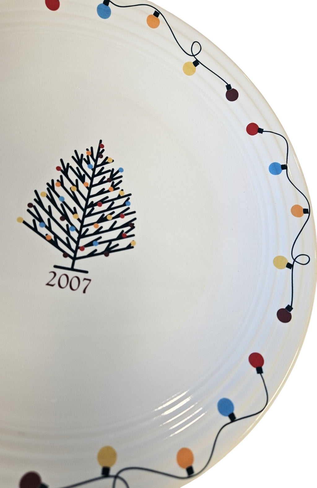 This is a Fiesta Fiestaware Chop Plate featuring JC Penney's exclusive 2007 String of Lights, AKA Light Motif on White. Post 1986, Lead-free, Christmas, Tree, Decorated, Decal
