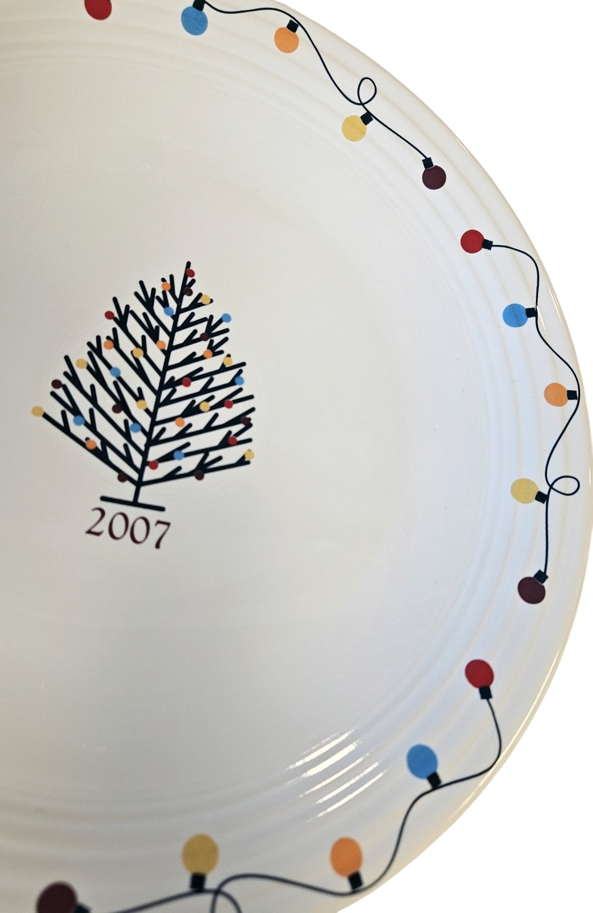 This is a Fiesta Fiestaware Chop Plate featuring JC Penney's exclusive 2007 String of Lights, AKA Light Motif on White. Post 1986, Lead-free, Christmas, Tree, Decorated, Decal
