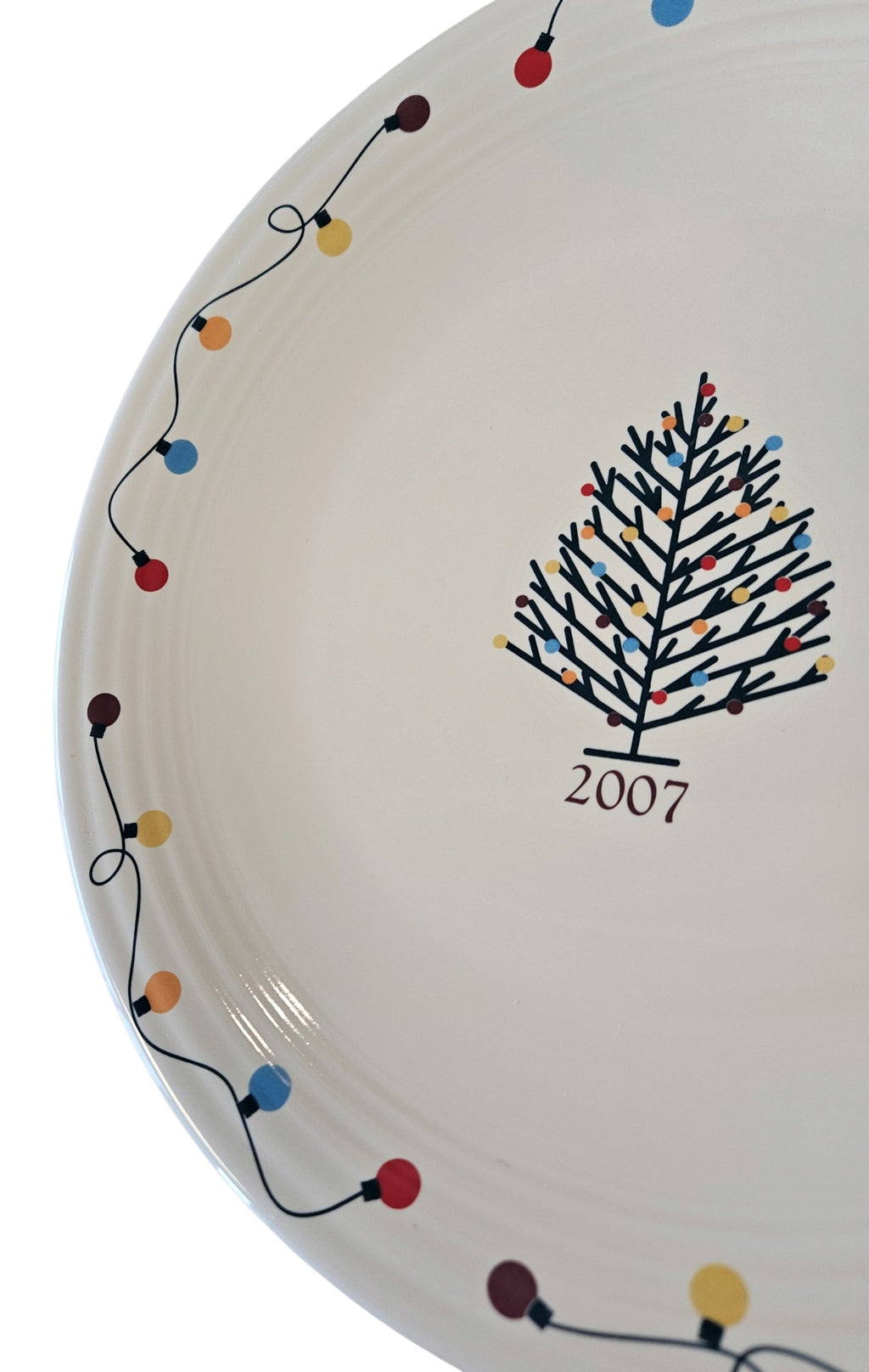 This is a Fiesta Fiestaware Chop Plate featuring JC Penney's exclusive 2007 String of Lights, AKA Light Motif on White. Post 1986, Lead-free, Christmas, Tree, Decorated, Decal

