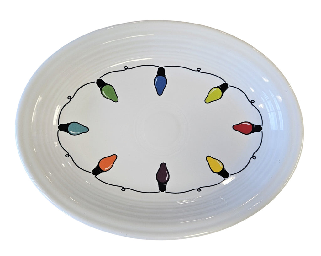 This is a Fiesta Fiestaware Medium Oval Platter featuring the decal sometimes called Bon-Ton's Christmas Lights, String of Lights, or Holiday Lights on White. Post 1986, Lead-free, Christmas, Tree, Decorated, Retired Decal
