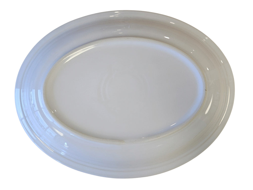 This is a Fiesta Fiestaware Medium Oval Platter featuring the decal sometimes called Bon-Ton's Christmas Lights, String of Lights, or Holiday Lights on White. Post 1986, Lead-free, Christmas, Tree, Decorated, Retired Decal

