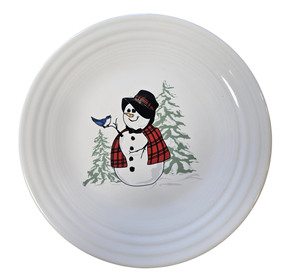 This is a Fiesta Fiestaware Classic Luncheon Plate featuring the Snowlady decal on White. Post 1986, Lead-free, Decorated, Christmas
