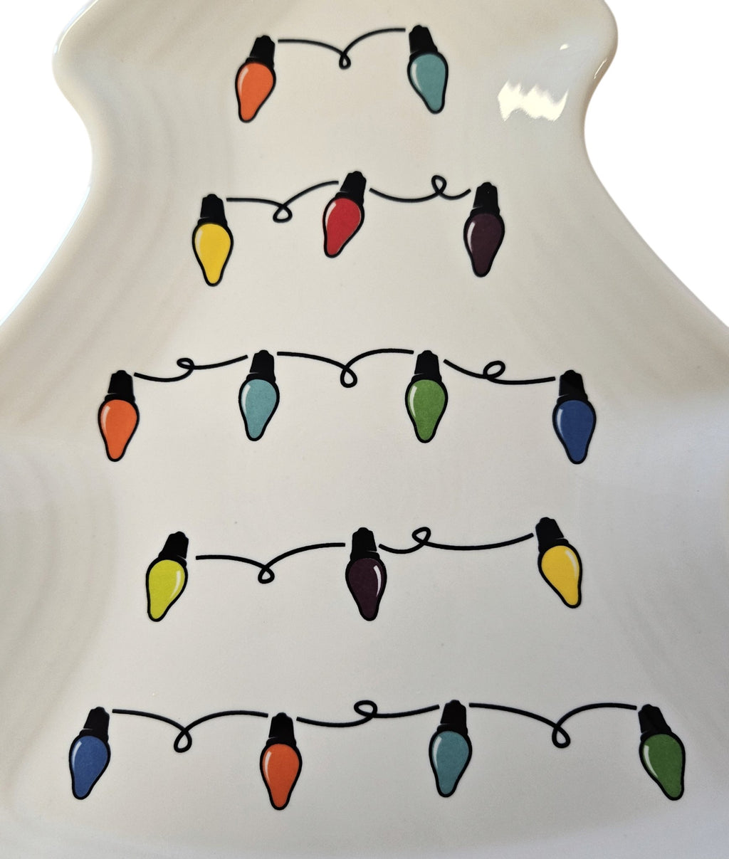 This is a Fiesta Fiestaware Tree Shaped Plate featuring the decal sometimes called Bon-Ton's Christmas Lights, String of Lights, or Holiday Lights on White. Post 1986, Lead-free, Christmas, Tree, Decorated, Retired Decal
