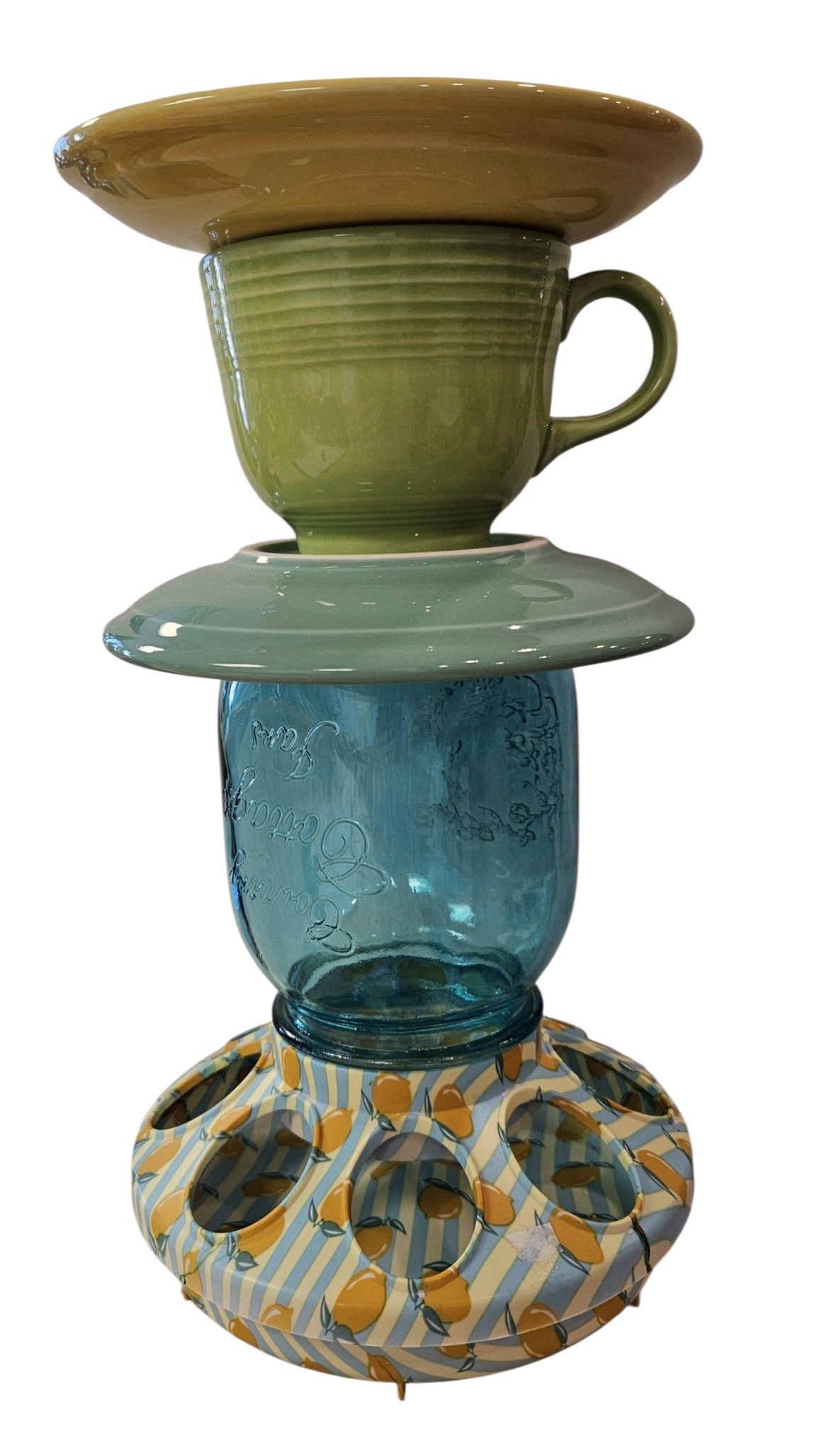 This is a handcrafted Birdfeeder made from a Fiesta Fiestware Cup and two saucers. It includes a glass jar to hold birdseed and either a plastic or metal base for the birds to land and feast. The top saucer is also perfect to hold grape jam or orange slices to feed your local orioles. Please see item description for specific cup and saucer color, jar color and base type. Crafted, Fiesta Second Life
