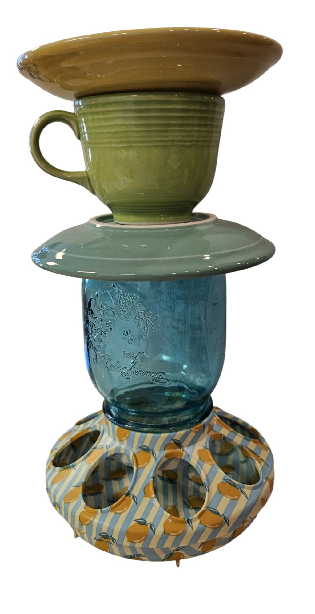 This is a handcrafted Birdfeeder made from a Fiesta Fiestware Cup and two saucers. It includes a glass jar to hold birdseed and either a plastic or metal base for the birds to land and feast. The top saucer is also perfect to hold grape jam or orange slices to feed your local orioles. Please see item description for specific cup and saucer color, jar color and base type. Crafted, Fiesta Second Life
