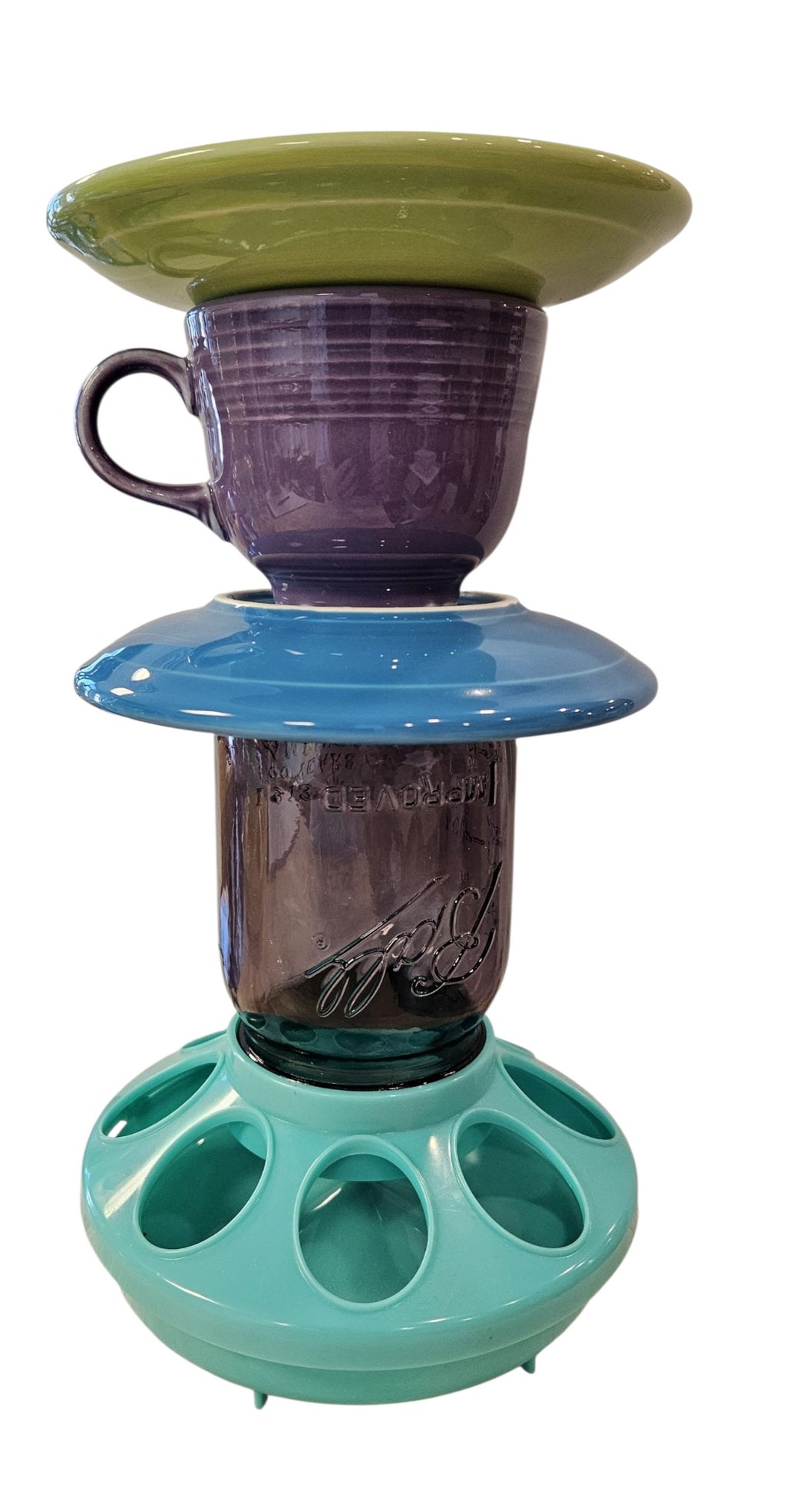 This is a handcrafted Birdfeeder made from a Fiesta Fiestware Cup and two saucers. It includes a glass jar to hold birdseed and either a plastic or metal base for the birds to land and feast. The top saucer is also perfect to hold grape jam or orange slices to feed your local orioles. Please see item description for specific cup and saucer color, jar color and base type. Crafted, Fiesta Second Life
