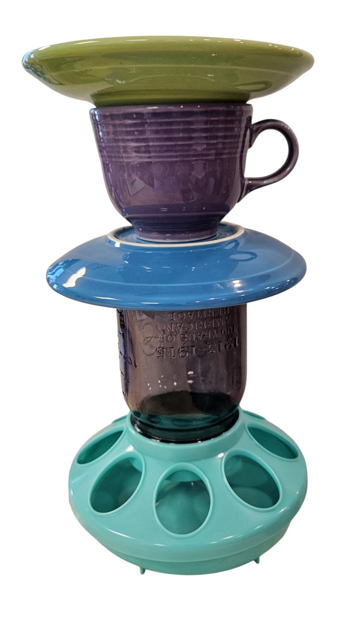 This is a handcrafted Birdfeeder made from a Fiesta Fiestware Cup and two saucers. It includes a glass jar to hold birdseed and either a plastic or metal base for the birds to land and feast. The top saucer is also perfect to hold grape jam or orange slices to feed your local orioles. Please see item description for specific cup and saucer color, jar color and base type. Crafted, Fiesta Second Life
