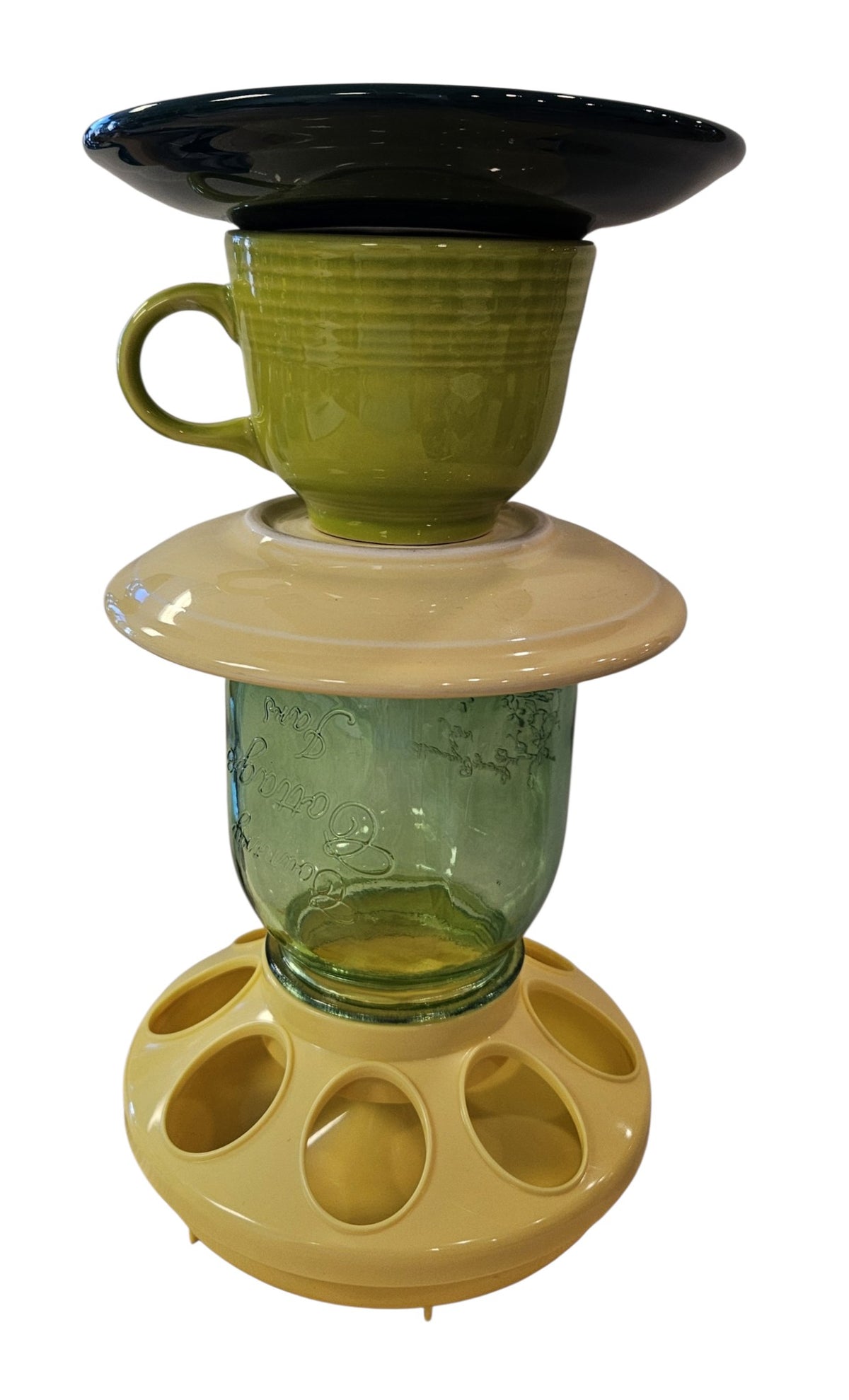 This is a handcrafted Birdfeeder made from a Fiesta Fiestware Cup and two saucers. It includes a glass jar to hold birdseed and either a plastic or metal base for the birds to land and feast. The top saucer is also perfect to hold grape jam or orange slices to feed your local orioles. Please see item description for specific cup and saucer color, jar color and base type. Crafted, Fiesta Second Life
