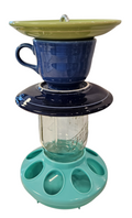 This is a handcrafted Birdfeeder made from a Fiesta Fiestware Cup and two saucers. It includes a glass jar to hold birdseed and either a plastic or metal base for the birds to land and feast. The top saucer is also perfect to hold grape jam or orange slices to feed your local orioles. Please see item description for specific cup and saucer color, jar color and base type. Crafted, Fiesta Second Life
