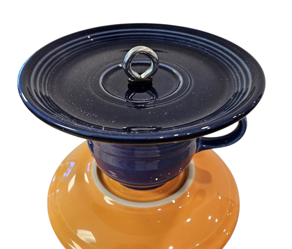 This is a handcrafted Birdfeeder made from a Fiesta Fiestware Cup and two saucers. It includes a glass jar to hold birdseed and either a plastic or metal base for the birds to land and feast. The top saucer is also perfect to hold grape jam or orange slices to feed your local orioles. Please see item description for specific cup and saucer color, jar color and base type. Crafted, Fiesta Second Life
