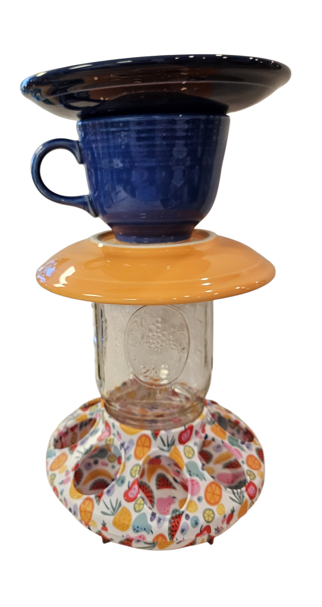 This is a handcrafted Birdfeeder made from a Fiesta Fiestware Cup and two saucers. It includes a glass jar to hold birdseed and either a plastic or metal base for the birds to land and feast. The top saucer is also perfect to hold grape jam or orange slices to feed your local orioles. Please see item description for specific cup and saucer color, jar color and base type. Crafted, Fiesta Second Life
