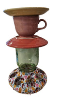 This is a handcrafted Birdfeeder made from a Fiesta Fiestware Cup and two saucers. It includes a glass jar to hold birdseed and either a plastic or metal base for the birds to land and feast. The top saucer is also perfect to hold grape jam or orange slices to feed your local orioles. Please see item description for specific cup and saucer color, jar color and base type. Crafted, Fiesta Second Life
