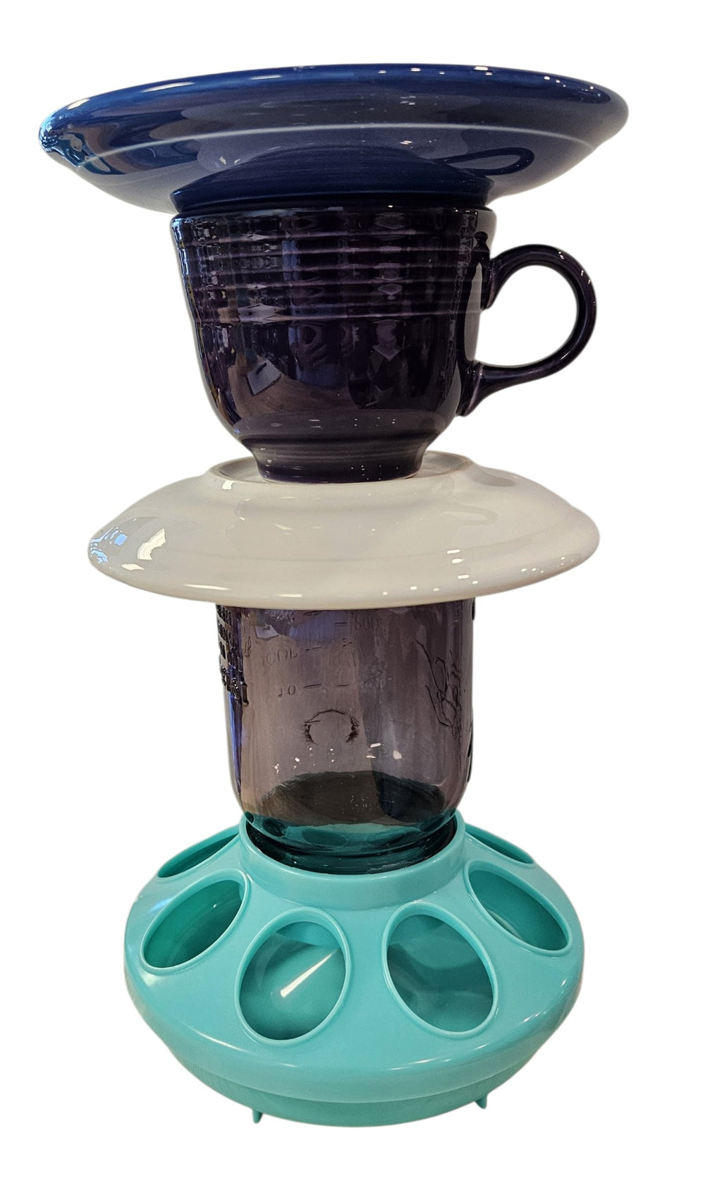 This is a handcrafted Birdfeeder made from a Fiesta Fiestware Cup and two saucers. It includes a glass jar to hold birdseed and either a plastic or metal base for the birds to land and feast. The top saucer is also perfect to hold grape jam or orange slices to feed your local orioles. Please see item description for specific cup and saucer color, jar color and base type. Crafted, Fiesta Second Life
