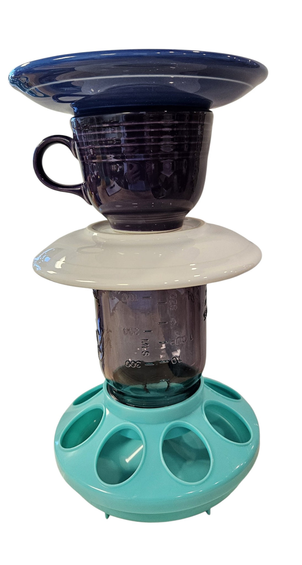 This is a handcrafted Birdfeeder made from a Fiesta Fiestware Cup and two saucers. It includes a glass jar to hold birdseed and either a plastic or metal base for the birds to land and feast. The top saucer is also perfect to hold grape jam or orange slices to feed your local orioles. Please see item description for specific cup and saucer color, jar color and base type. Crafted, Fiesta Second Life
