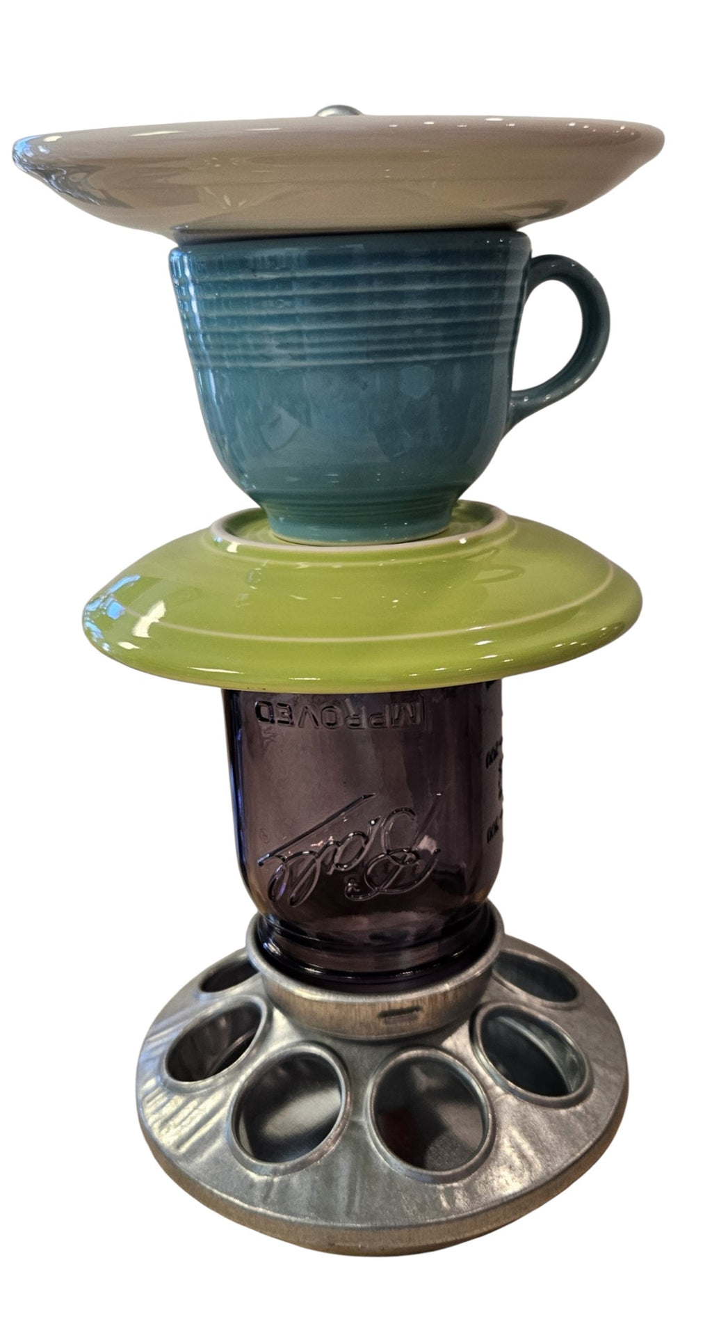 This is a handcrafted Birdfeeder made from a Fiesta Fiestware Cup and two saucers. It includes a glass jar to hold birdseed and either a plastic or metal base for the birds to land and feast. The top saucer is also perfect to hold grape jam or orange slices to feed your local orioles. Please see item description for specific cup and saucer color, jar color and base type. Crafted, Fiesta Second Life

