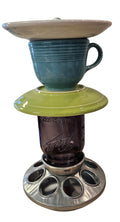 This is a handcrafted Birdfeeder made from a Fiesta Fiestware Cup and two saucers. It includes a glass jar to hold birdseed and either a plastic or metal base for the birds to land and feast. The top saucer is also perfect to hold grape jam or orange slices to feed your local orioles. Please see item description for specific cup and saucer color, jar color and base type. Crafted, Fiesta Second Life
