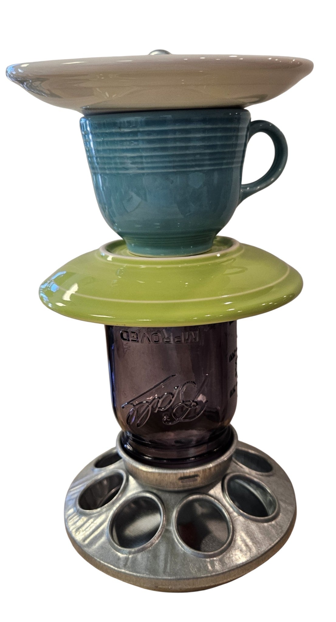 This is a handcrafted Birdfeeder made from a Fiesta Fiestware Cup and two saucers. It includes a glass jar to hold birdseed and either a plastic or metal base for the birds to land and feast. The top saucer is also perfect to hold grape jam or orange slices to feed your local orioles. Please see item description for specific cup and saucer color, jar color and base type. Crafted, Fiesta Second Life
