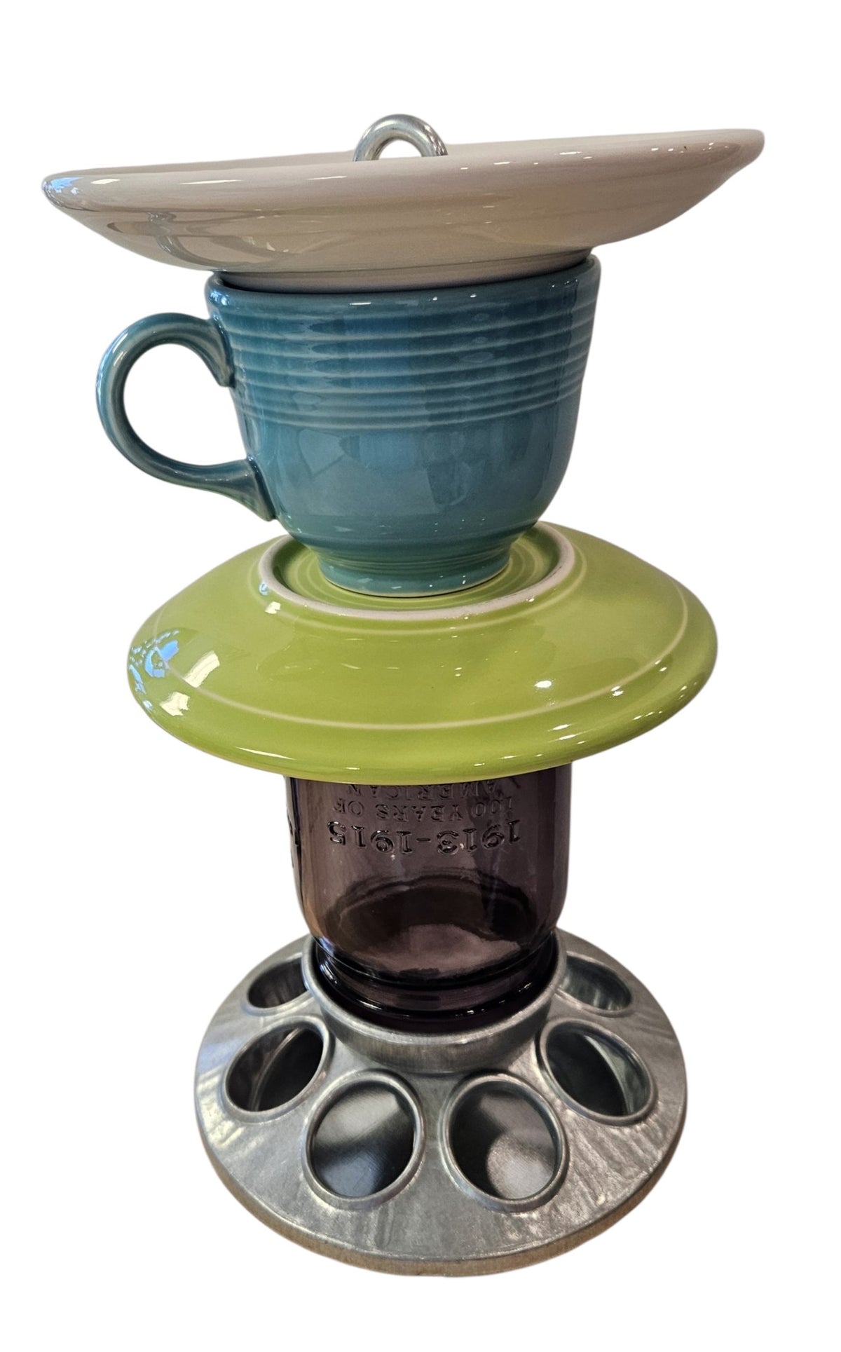 This is a handcrafted Birdfeeder made from a Fiesta Fiestware Cup and two saucers. It includes a glass jar to hold birdseed and either a plastic or metal base for the birds to land and feast. The top saucer is also perfect to hold grape jam or orange slices to feed your local orioles. Please see item description for specific cup and saucer color, jar color and base type. Crafted, Fiesta Second Life
